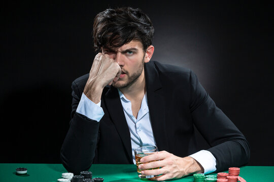 Sad Frustrated Handsome Caucasian Brunet Young Pocker Player At Pocker Table With Chips And Cards