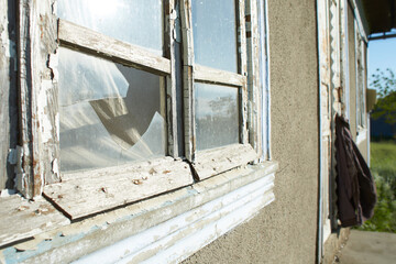 Old window with cobweb in old abandoned yard. View from indoor