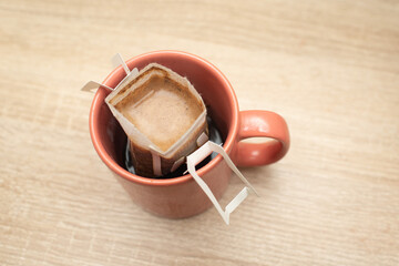 Coffee Drips pack in cup. Alternative brewing specialty coffee in paper filter bags.