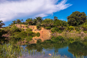 Scenic landscape view of a natural lagoon with transparent turquoise water in rainforest jungle at North Borneo