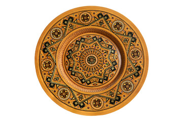 Isolated on white wooden souvenir plate with carved and decorated ornament