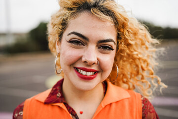 Bohemian young girl smiling on camera outdoor - Focus on girl face