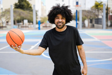 Young african man playing basketball outdoor - Focus on face
