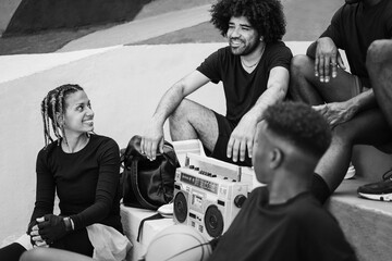 Young african people listening music outdoor after basketball match - Focus on left man face -...