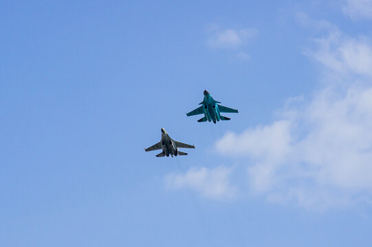 MAKS-2011. Soviet-Russian multi-purpose aircraft Su-35 (NATO - Flanker-E) and Su-34 (NATO - Fullback) generation 4 ++ perform paired horizontal flight. Close-up. Zhukovsky, Russia - August 16, 2011