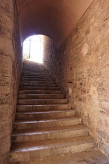 walkway with stone walls and stairs, view from below