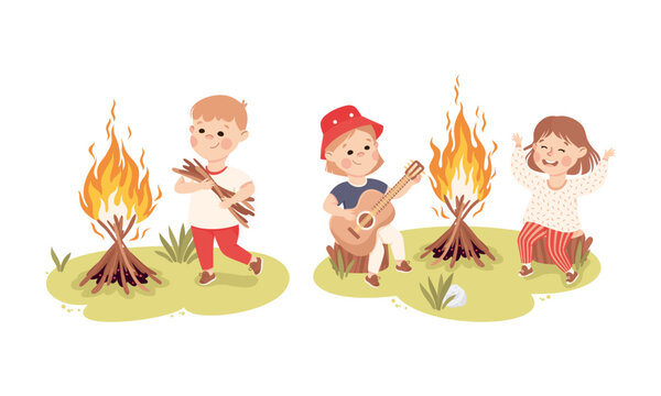 Little children camping around bonfire. Boy carrying bunch of firewood kids playing guitar and singing cartoon vector illustration