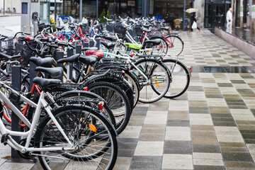 bikes parked on street in rainy weather - 524232989