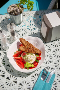 Burato cheese and red tomato with croutons, watercress salad and other green herbs