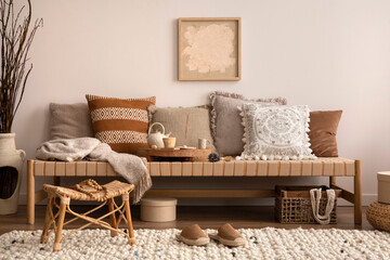 Boho and cozy interior of meditation room with beige chaise lounge, carpet, rattan pouf, pillows,...