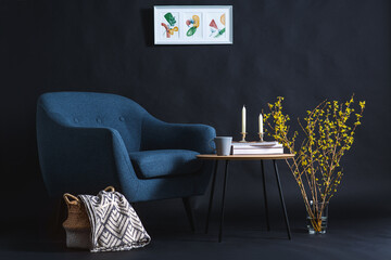 interior and home decor concept - close up of blue chair, coffee table and blanket in basket in...