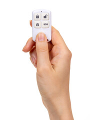 Fototapeta premium A woman's hand holds a wireless control key fob for a smart home, alarm, lock. Isolated on white background