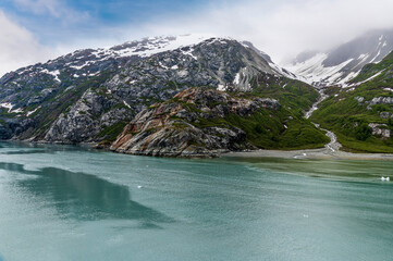A view of moraine deposits at the waters edge in Glacier Bay beside the Reid Glacier, Alaska in...