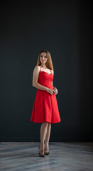 young beautiful woman on a dark background, full length studio shot