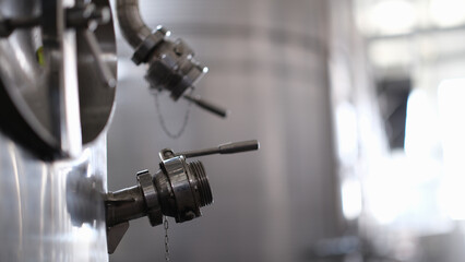 Fototapeta na wymiar Industrial stainless steel silo and crane used in modern winemaking