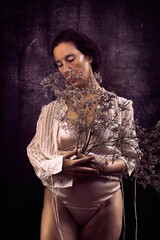 woman hugging a bush of wild flowers VII