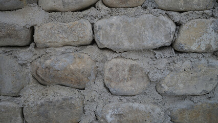 Old castle stone wall texture background. Finishing the facade with stone