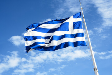 Close-up of Greek flag flying over the Acropolis