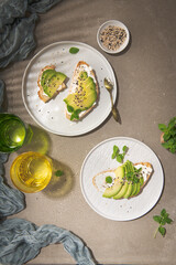 Healthy toast with avocado cream cheese and wheat bread on a plate. Delicious snacks and avocado sandwiches. Food composition, tasty Italian meal.