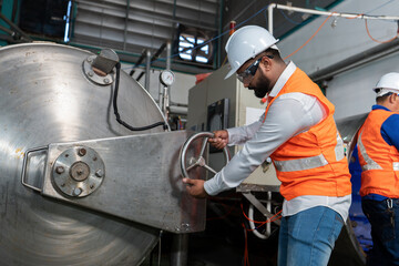Mechanical aintenance engineer operate hand wheel shut off valve control boiler at the pressure...