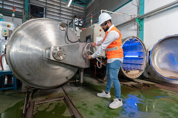 Mechanical aintenance engineer operate hand wheel shut off valve control boiler at the pressure...