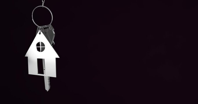 Animation of silver house keys hanging against black background with copy space
