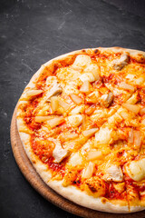 hot delicious traditional italian pizza on a dark stone background