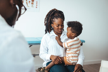 Pediatrician's Office. Shot of a single mother bringing his little boy for a checkup. An adorable...