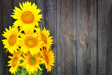 A bouquet of sunflowers on the background of a wooden wall