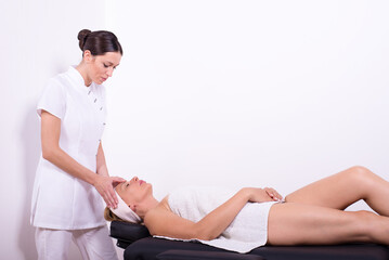 Fototapeta na wymiar Young woman getting massage therapy in massage salon