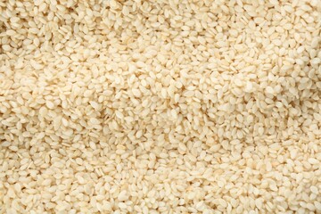 Pile of white sesame seeds as background, top view
