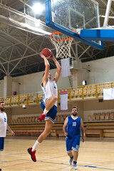 Basketball players playing basketball in the sports hall