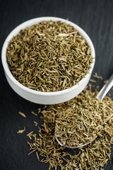 fragrant dried thyme on a dark stone background