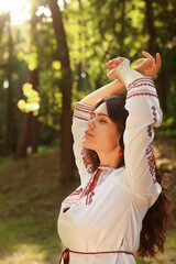 Beautiful woman in embroidered shirt outdoors. Ukrainian national clothes