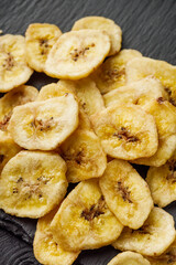delicious dried banana on a black wooden rustic background