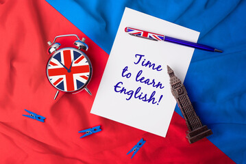 Time to learn English. UK flag pen with a clock and a card to write messages. Study a new language