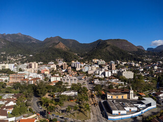 Aerial view of the city of Teres&oacute;polis. Mountains and hills with blue sky and many houses in the mountain region of Rio de Janeiro, Brazil. Drone photo. Araras, Teres&oacute;polis. Sunny day. Sunrise