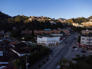 Aerial view of the city of Teres&oacute;polis. Mountains and hills with blue sky and many houses in the mountain region of Rio de Janeiro, Brazil. Drone photo. Araras, Teres&oacute;polis. Sunny day. Sunset