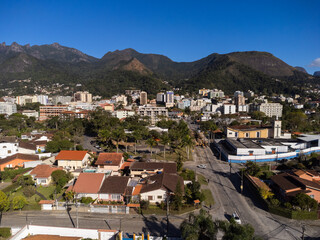 Aerial view of the city of Teresópolis. Mountains and hills with blue sky and many houses in the mountain region of Rio de Janeiro, Brazil. Drone photo. Araras, Teresópolis. Sunny day. Sunrise