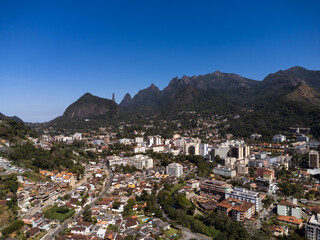 Aerial view of the city of Teresópolis. Mountains and hills with blue sky and many houses in the mountain region of Rio de Janeiro, Brazil. Drone photo. Araras, Teresópolis. Sunny day. Sunrise