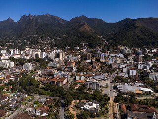 Aerial view of the city of Teresópolis. Mountains and hills with blue sky and many houses in the mountain region of Rio de Janeiro, Brazil. Drone photo. Araras, Teresópolis. Sunny day. Sunrise