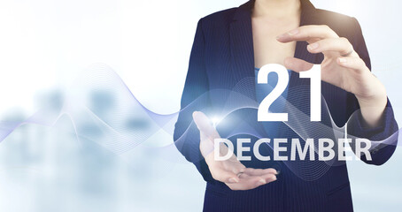 December 21st . Day 21 of month, Calendar date. Hand hold virtual hologram calendar date with digital wave.  Winter month, day of the year concept.