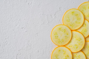 yellow zucchini sliced. White background.