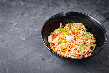delicious chinese fried noodles on a black background