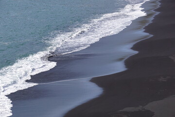 Reynisfjara - black beach in Iceland, close-up on waves