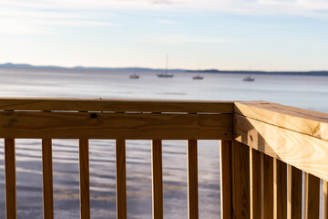 Handrail in the foreground with Penobscot bay and moored boats in the background