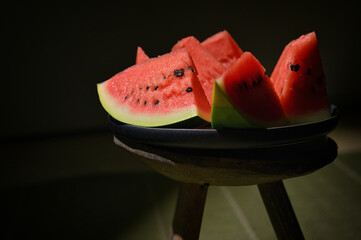 Sliced watermelon on a plate and old chair