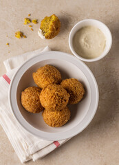 Falafel - popular middle eastern street food with garlic sauce. Top view. Scrumptious vegetarian dish from Middle east called Falafil shot from above angle.