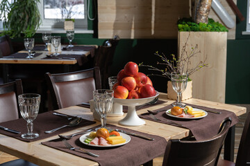 Morning breakfast, ham, cheese, bun and butter. Beautifully set table for several people in a restaurant.