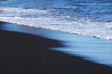 Reynisfjara - black beach in Iceland, close-up on waves